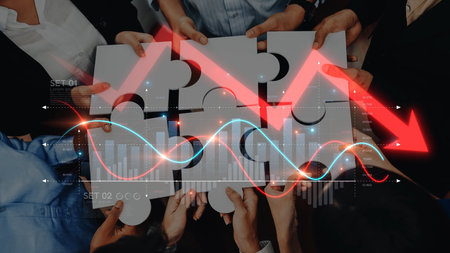 A diverse group collaborates over puzzle pieces while charts display a decline, representing...