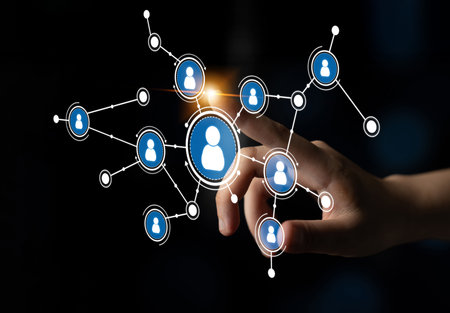A hand reaches out to interact with digital user icons representing social connections, illustrating...