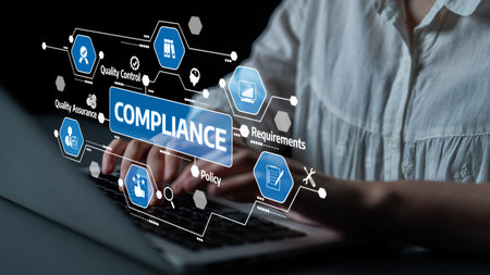 A professional working on a laptop showcases the importance of compliance management through quality...