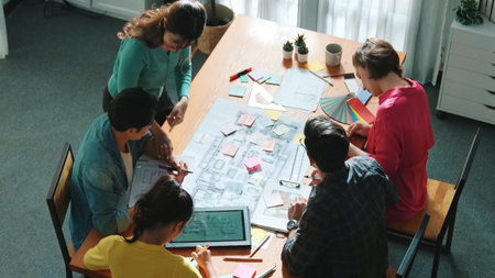 Top view of skilled civil engineer team writing at blueprint and planning design. Professional...
