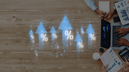 A business team collaborates on data analysis, featuring digital growth indicators and arrows. The...
