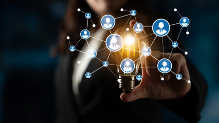 A business professional engages with a light bulb, symbolizing innovation and connectivity. The...