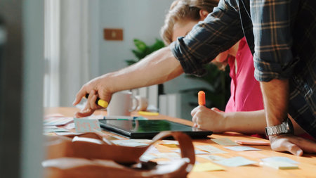 Smart project manager working together with businessman choosing logo design. Professional business...