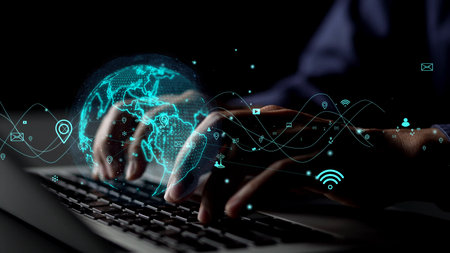 Concept of a modern workspace featuring hands typing on a laptop with futuristic graphics of a...