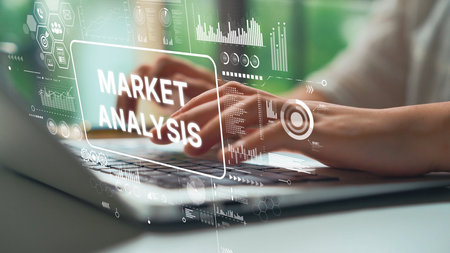 Close-Up of Hands Typing on Laptop with Overlay of Market Analysis Graphics and Data Visualization...