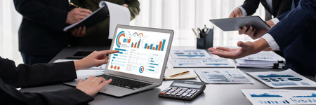 Panorama shot analyst team utilizing BI Fintech to analyze financial report with laptop....