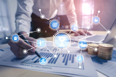 A business professional studies financial data and digital icons in a modern office setting,...