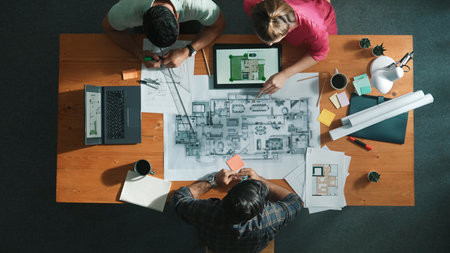 Top down view of civil engineer handed document while looking at blueprint. Aerial view of architect...