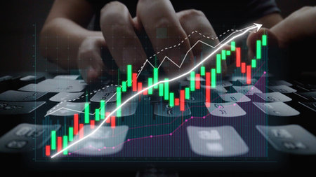 Focus on a person typing on a keyboard, with dynamic stock market graphs displayed, representing the...