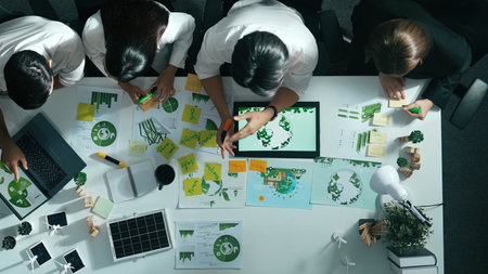 Top view of executive manager hold tablet display clean energy at meeting. Aerial view of business...