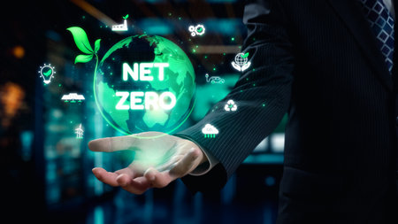 A businessman presents a holographic globe featuring a net zero message, surrounded by icons...