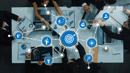 Engaging business meeting with a diverse team analyzing charts and graphs on digital devices,...