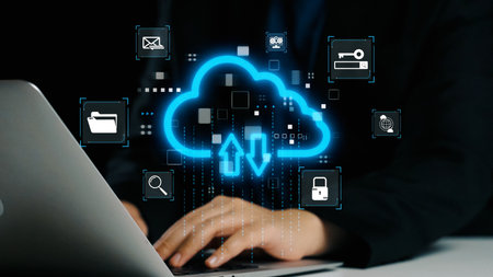 A person interacts with a laptop surrounded by cloud computing icons and data upload symbols,...