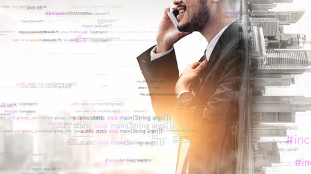 A professional businessman in a suit engages in phone conversation amidst a backdrop of abstract...
