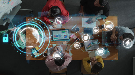 A dynamic business team collaborates with advanced digital technology in a modern office setting,...