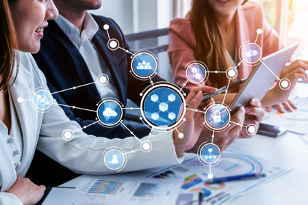 Professionals engage in a collaborative meeting, sharing ideas and presenting digital data on a...