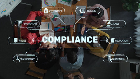 Team of professionals engaged in a collaborative meeting, discussing compliance strategies with charts and documents, showcasing teamwork and effective planning. Rasterの写真素材