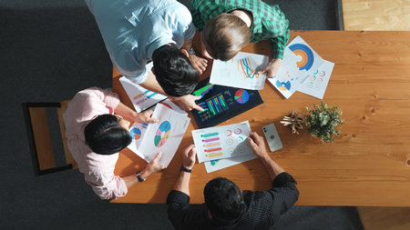 Top down aerial view of smart business people analyze data together at meeting. Group of business...