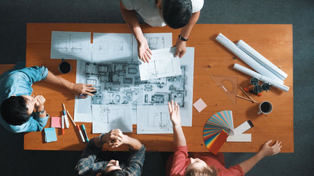 Top view of smart architect engineer team talking about project plan while manager walking at...