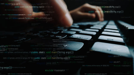 A close-up shot of hands typing on a computer keyboard immersed in lines of code, showcasing the...
