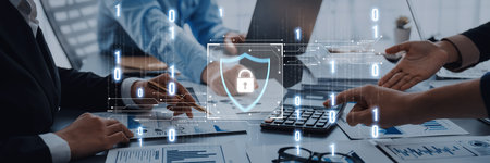 Professionals engage in a business meeting focused on cybersecurity solutions, with charts and...