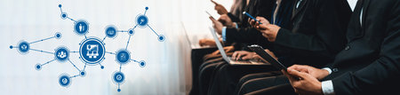 A group of business professionals using smartphones and laptops illustrates the impact of technology...
