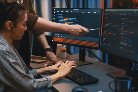 IT developers discussing with point to intelligent website development coder system running data...