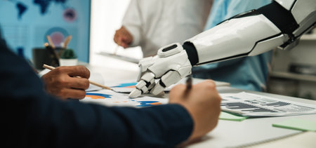 Human and robot collaborate in a modern office setting, focusing on data analysis and innovation. A...