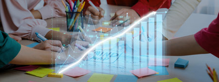 A group of professionals engaged in brainstorming sessions with colorful sticky notes and digital...