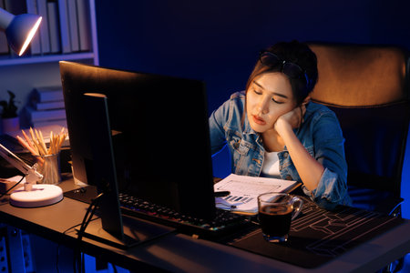 Stressful young beautiful asian creative looking on pc to search project creator social media online...