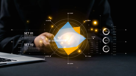 A futuristic data analysis scene featuring a hand holding a mobile phone above a table, alongside a...
