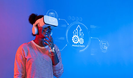 A young woman engages with virtual reality, smiling as she explores a vibrant digital interface that...