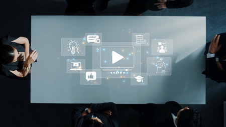 A top-down view of a business meeting at a sleek conference table with digital icons showcasing...