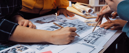 A diverse team engages in a collaborative design session, working together on detailed architectural...