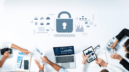 Diverse professionals engage in cybersecurity discussions using digital devices and charts, illustrating modern teamwork in a secure business environment.の写真素材