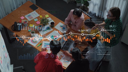 A diverse team engaged in an important business meeting, analyzing data visualizations and...