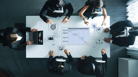 A diverse business team engages in innovative collaboration using virtual reality technology at a...