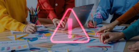 A diverse team engages in strategic marketing planning while highlighting potential risks and warnings in a modern office setting, showcasing collaboration and creativity.の写真素材