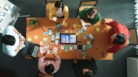 Top view of developer team working together to write idea about Ux Ui design on whiteboard. Smart...