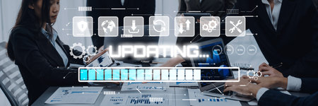 A modern business team works together in an office setting, focusing on digital device updates while...