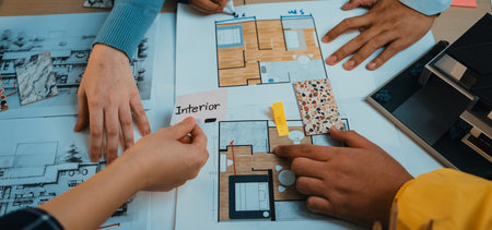 Engaging image of hands collaborating on interior design by reviewing sketches, color samples, and...