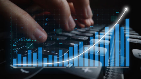 Close-up of hands typing on a computer keyboard with a digital graph overlay, symbolizing growth and...