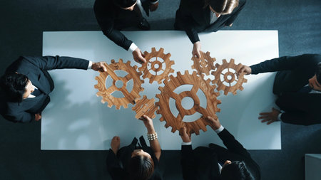 Top view of professional business team bring filled last cog to complete system. Group of smart...