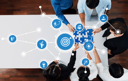 A business team collaboratively solving a puzzle symbolizing strategy and goals, utilizing digital...