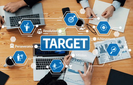 A collaborative business meeting showcases team members in discussion, utilizing laptops and...