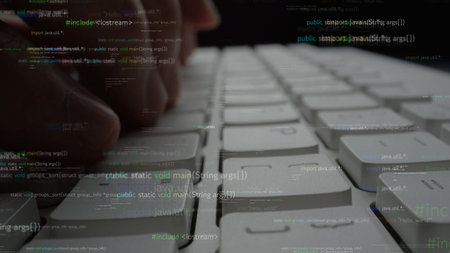 A close-up view of hands actively typing on a sleek keyboard surrounded by floating programming code...