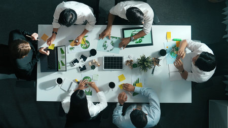 Top down view of business team discussing about using clean energy and sustainable investment at...