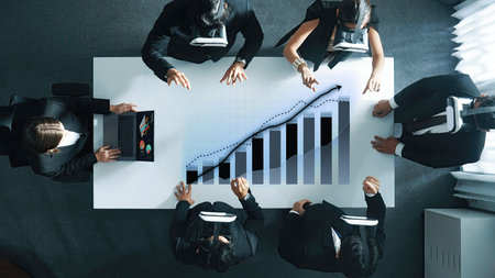 A dynamic business team engages in innovative data analysis using virtual reality headsets in a...