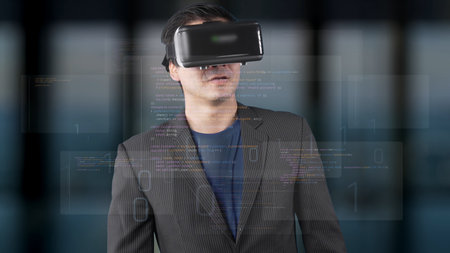 A businessman wearing a virtual reality headset stands in a modern office, immersed in digital data...