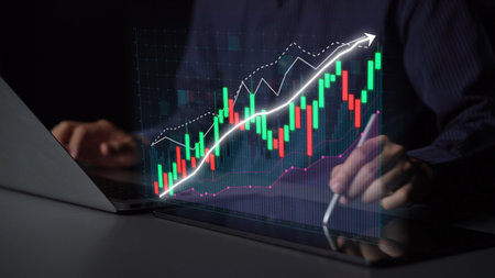 A professional engaging with digital financial data on a laptop, featuring glowing stock charts that...